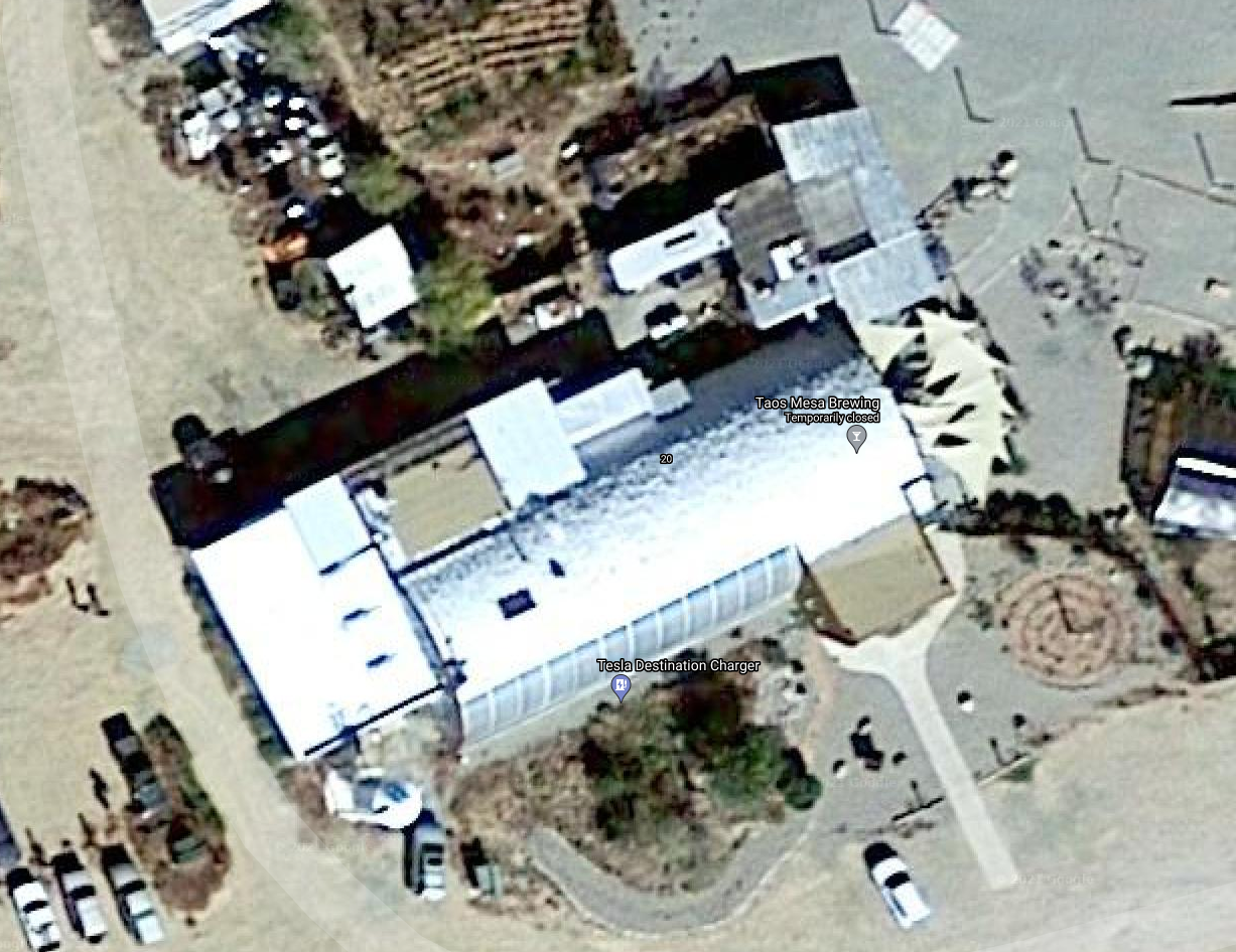 The meme is an image of a person standing in front of a building with a sign that reads "Elon Musk's Neuralink Factory". The image is likely a screenshot from Google Maps or a similar service, and the building is likely a real location that has been renamed or is being used as a joke to reference the Neuralink company, which is a neurotechnology startup founded by Elon Musk.
